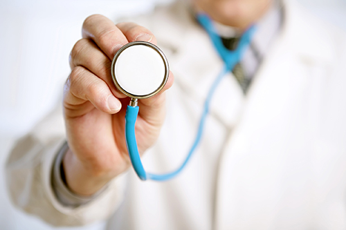 Close-up of a male doctor hand holding a stethoscope