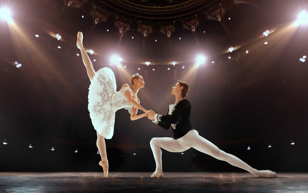 Ballet. Classical ballet performed by a couple of ballet dancers on the stage of the opera house.