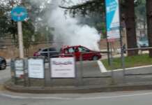 Auto in fiamme nel traffico: spavento per la conducente e due ragazzi